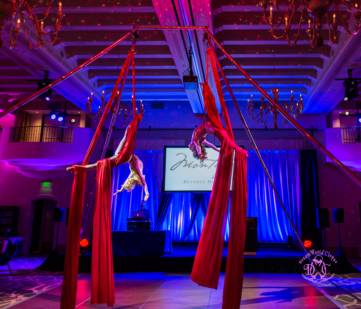 Contortionist in sparkly red costume performs bendy positions with her feet over her head